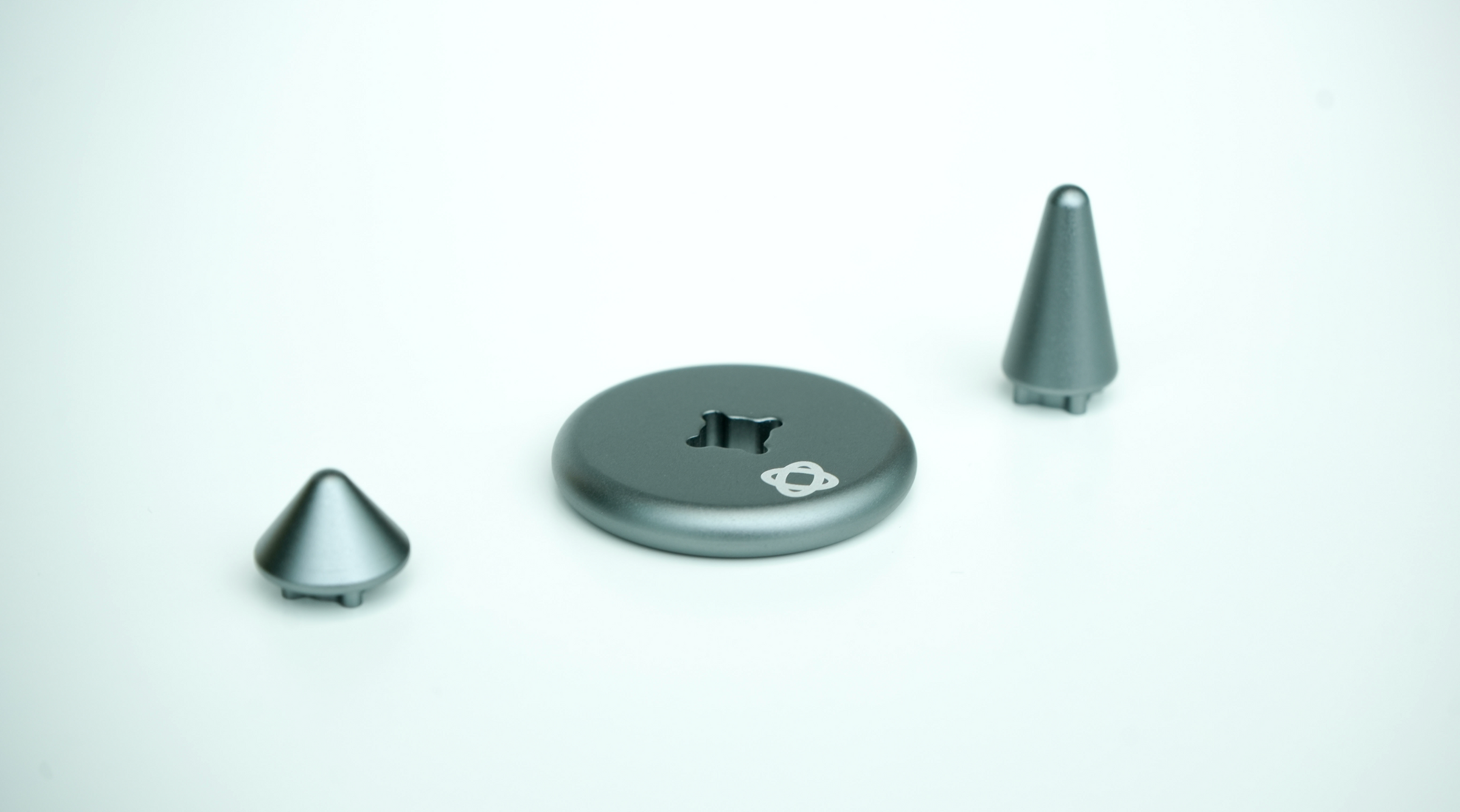 ST-01 spinning top three components laid out: body, middle coin, and base